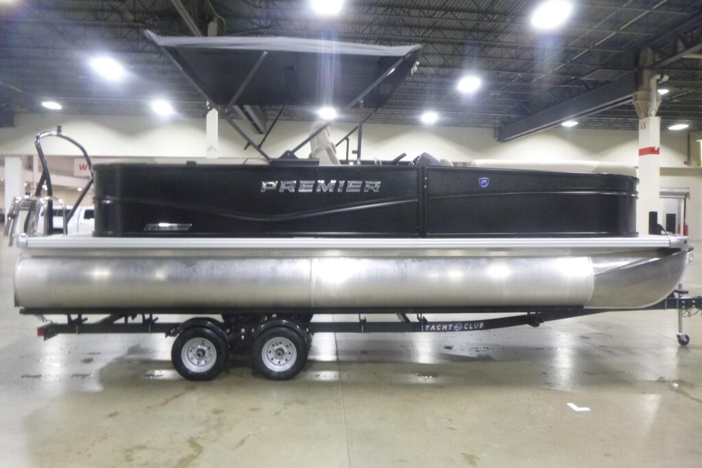 2026 Premier 220 Sunscape RF pontoon boat with bimini top on trailer displayed indoors