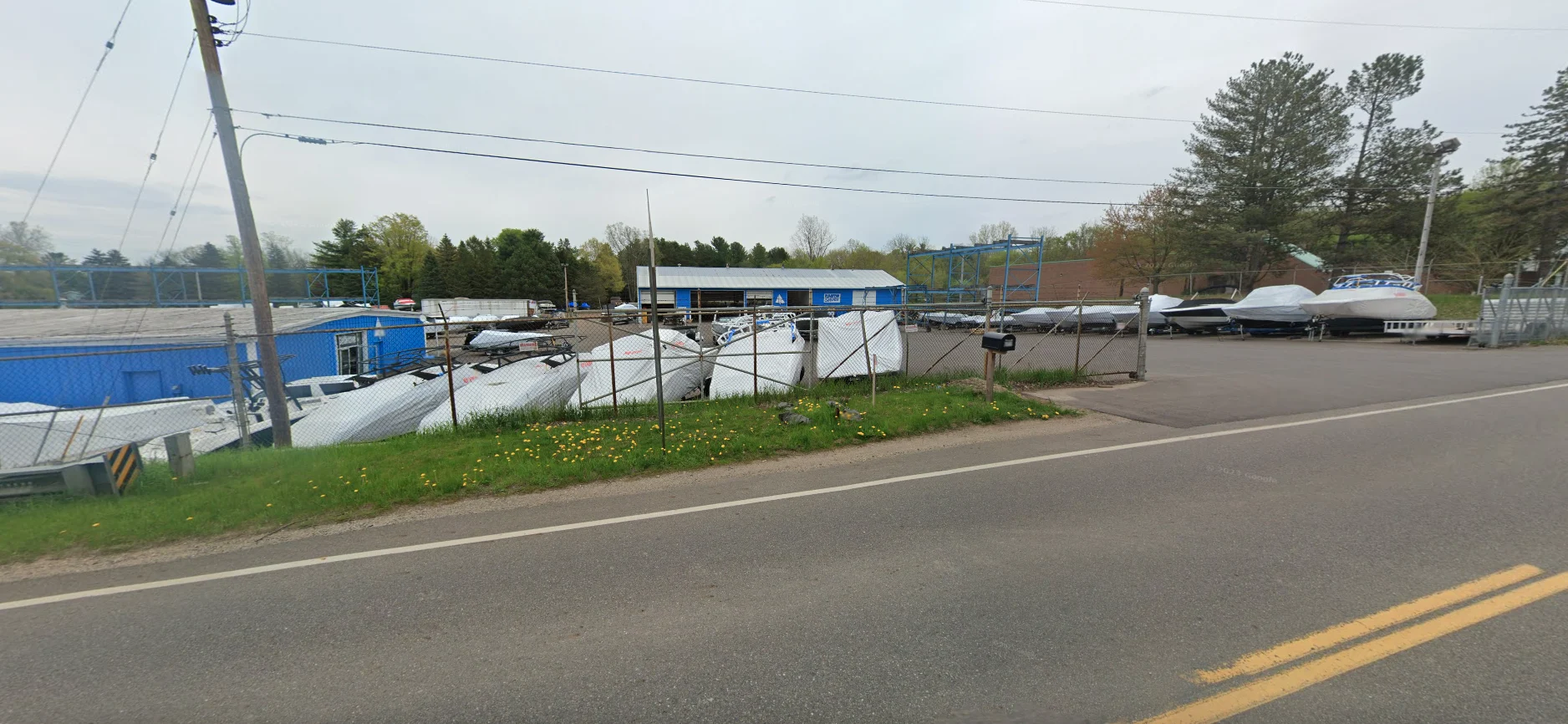 Grand Pointe Marina Lansing location exterior view featuring boats displayed at the marina facility in Lansing, Michigan.
