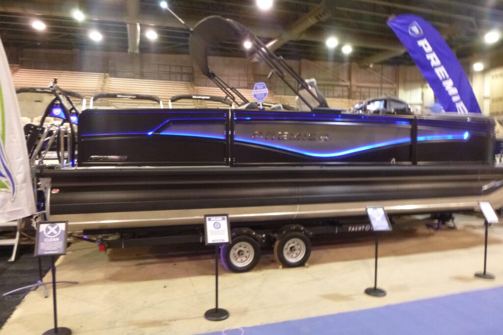 Premier 230 Intrigue RLO pontoon boat displayed at an indoor boat show