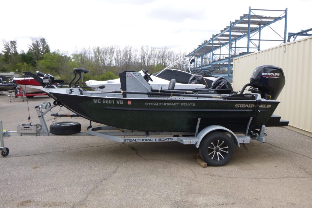 2025 StealthCraft 16 StealthWeld Power fishing boat on trailer with Mercury outboard motor at Grand Pointe Marina.