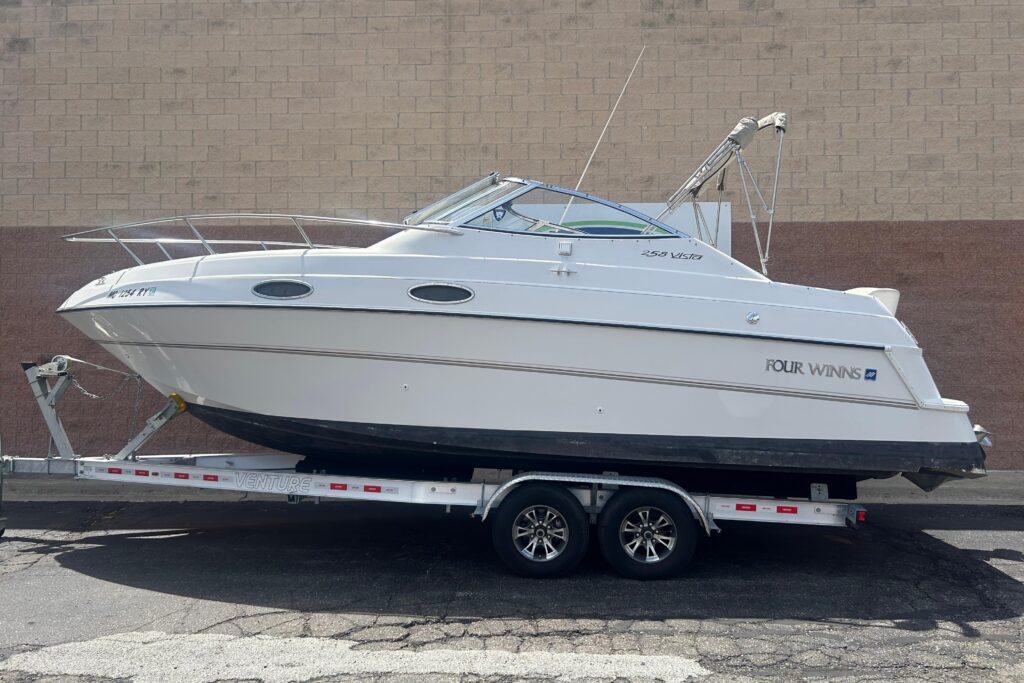 1998 Four Winns 258 Vista power cruiser on trailer showing white hull and side profile