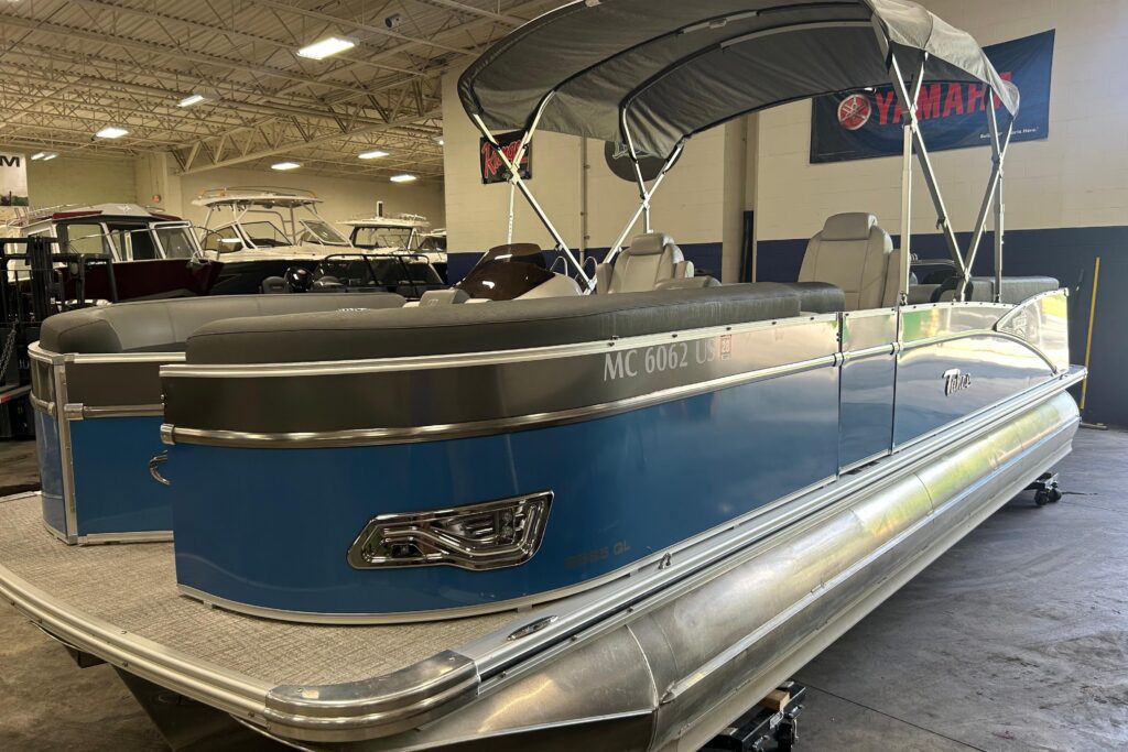 2022 Tahoe Pontoon Cascade Quad Lounger pontoon boat with blue exterior panels and black bimini top