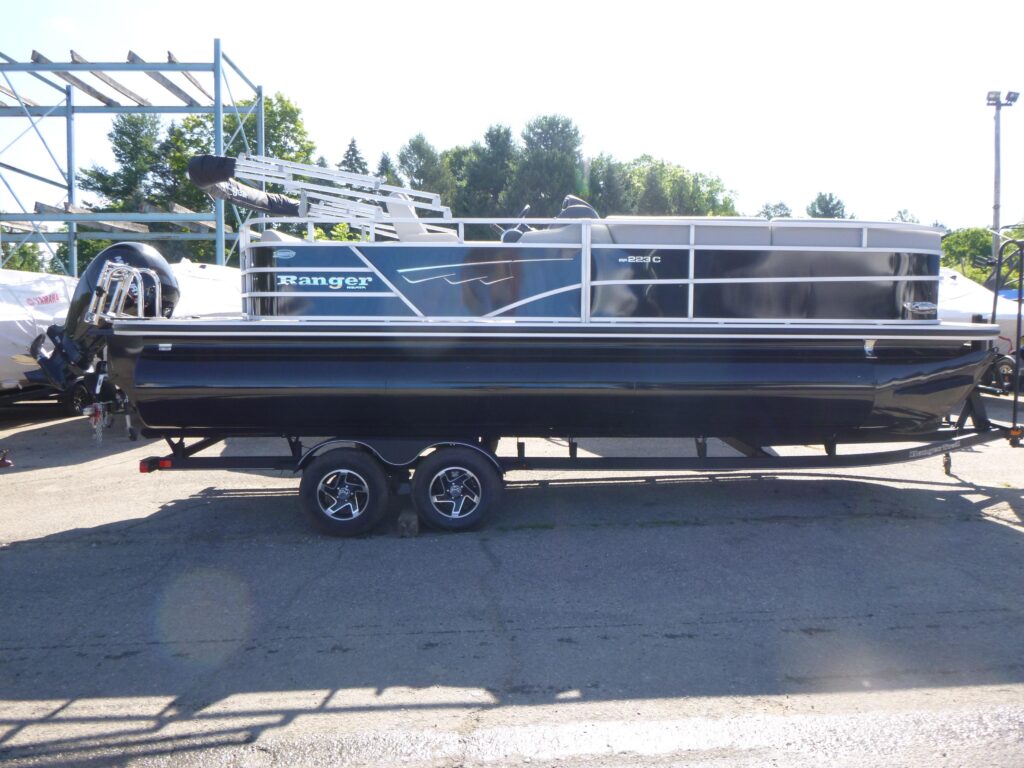 2024 Ranger Reata 223C pontoon boat on trailer with black exterior panels and Mercury outboard motor