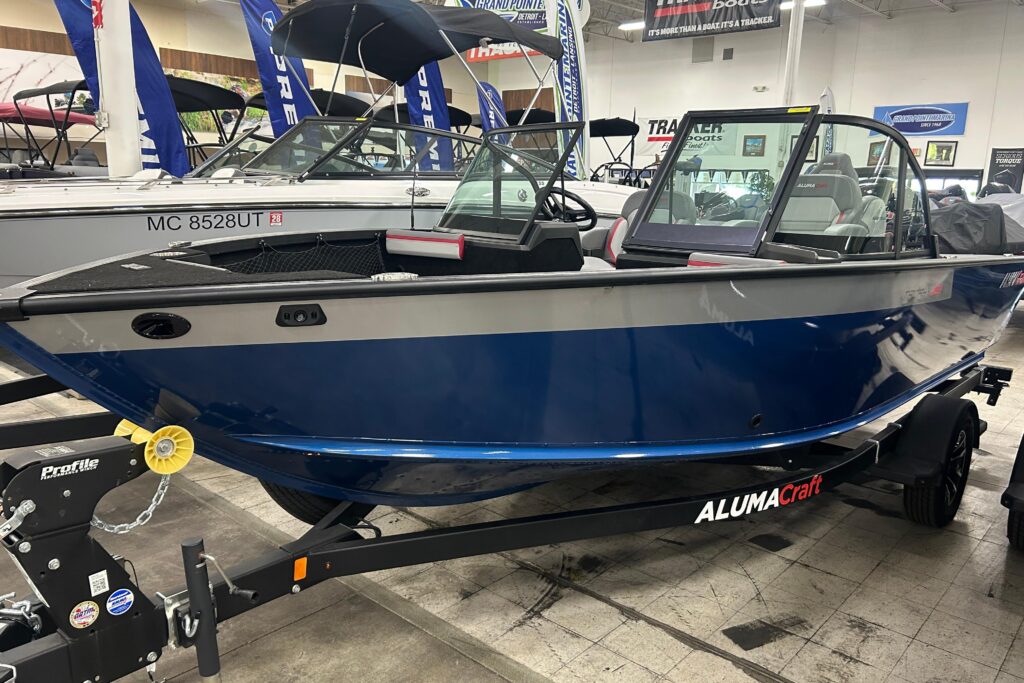 2025 Alumacraft Trophy 185X Sport fishing boat on trailer inside Grand Pointe Marina showroom