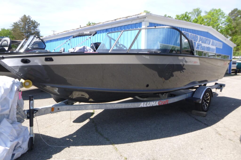 2025 Alumacraft Trophy 185X Sport fishing boat on trailer outside Grand Pointe Marina