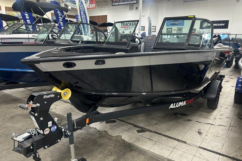 2026 Alumacraft Competitor 185X Sport fishing boat on trailer inside Grand Pointe Marina showroom